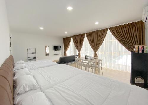 名古屋CN Homestay A3 Floor 1 at Nagoya Hill Mall的一间带一张白色大床的卧室和一间用餐室