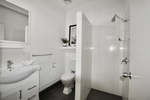 佩里吉安比奇亥努沙男性专用海滩度假酒店的白色的浴室设有卫生间和水槽。