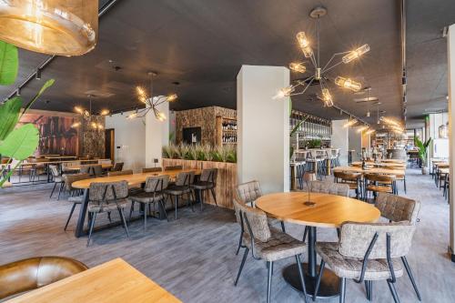 法尔肯堡Dormio Wijnhotel Valkenburg的用餐室配有木桌和椅子