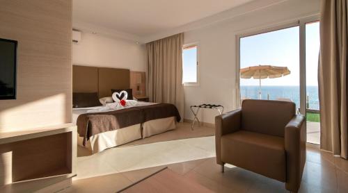 帕塔拉瓦卡Marina Elite的配有一张床和一把椅子的酒店客房