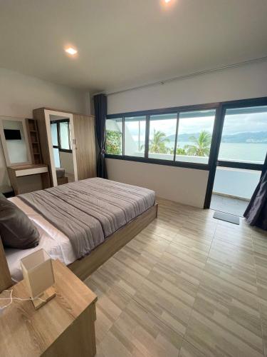 芭东海滩Garden Beach Sea View Patong的一间卧室配有一张床,享有海景