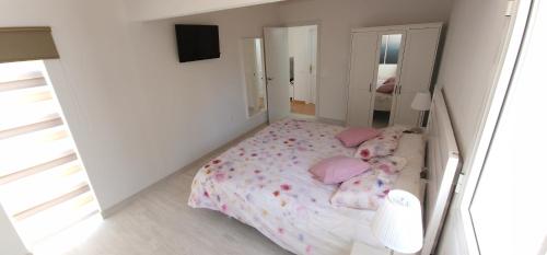 塔拉哈勒赫Casa Geminis, Relax, Sol y Jacuzzi的一间小卧室,配有一张带粉红色枕头的床