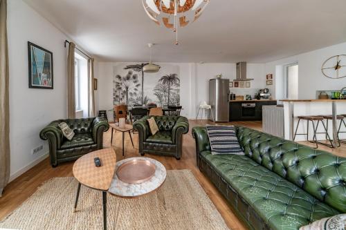 维希Grande Maison Vichy - Maison ou Appartements en Centre ville的客厅配有绿色沙发和椅子