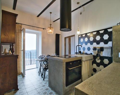 内米Suite sul Lago的厨房配有水槽和炉灶 顶部烤箱