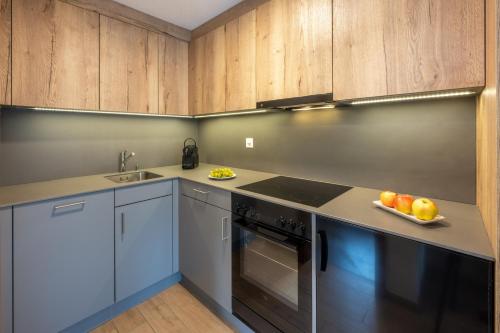采尔马特安妮塔酒店的厨房配有木制橱柜和一盘水果