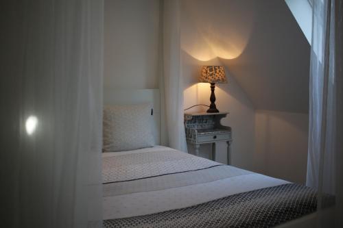 圣利芬斯－豪特姆The Suite Escape Apartment Sand的一间卧室配有一张床和一张桌子上的台灯
