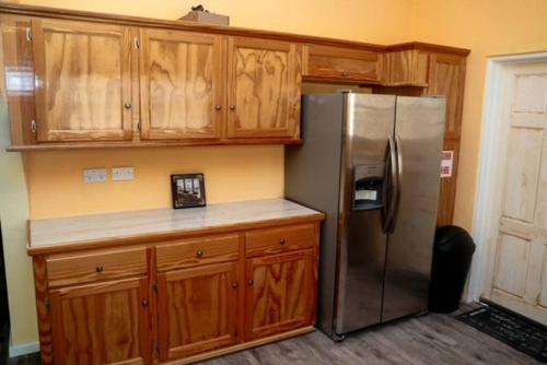 LaborieGlasgow Villa at La Mar的厨房配有不锈钢冰箱和木制橱柜