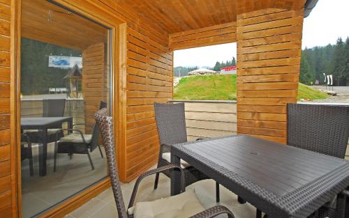 迪马诺卡多林纳Apartment Bartek Ski Rental的一个带桌椅的庭院和一个窗户。