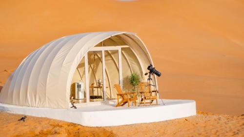 Badīyahalsaif camp的圆顶帐篷的模型,配有桌椅