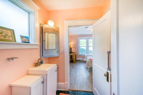 劳德代尔堡The Garden House的浴室设有橙色墙壁、水槽和镜子