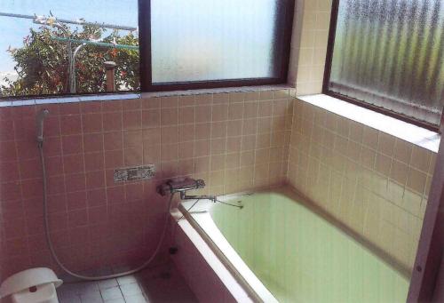 上天草Minshuku Hiro - Vacation STAY 84405v的带浴缸和卫生间的浴室以及窗户。