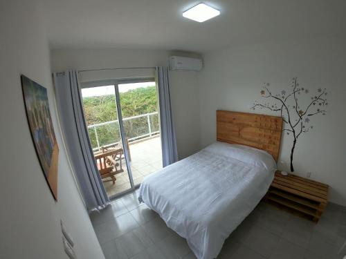 博卡德尔里奥Boca PentHouses - Tampiquera的一间卧室设有一张床和一个滑动玻璃门