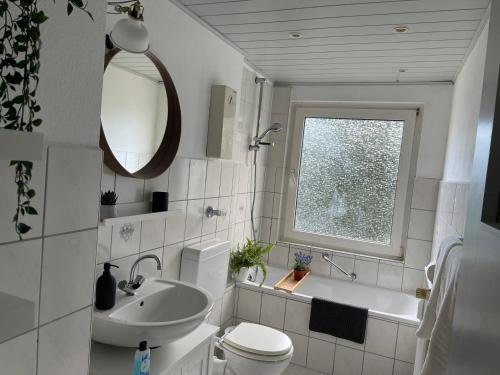 伍珀塔尔Wohnung in Wuppertal Elberfeld的浴室配有盥洗盆、卫生间和浴缸。