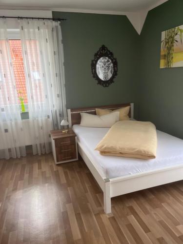 BremenGasthof Wulf的卧室配有白色的床和绿色的墙壁