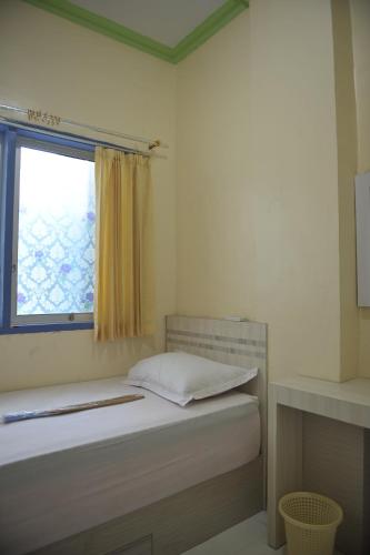 帕卢Penginapan AIRA的一间小卧室,配有床和窗户