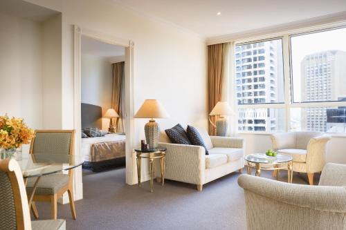 悉尼邦德街曼特拉2酒店的酒店客房设有一张特大号床和一间客厅。