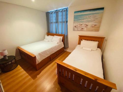 德班The Waves, 806 Quayside Point Waterfront的一间卧室设有两张床和窗户。