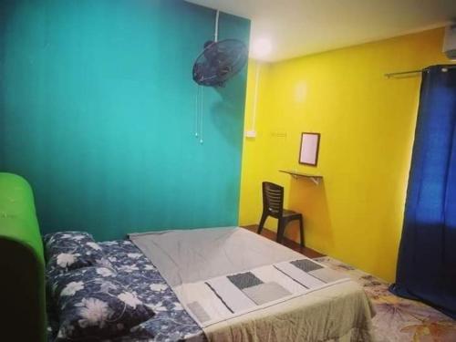 大港Chalet kolam renang D'sawah的一间卧室设有床和黄色及蓝色的墙壁