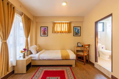 帕坦Bhrikuti Stay的一间卧室设有一张床、一个卫生间和一个窗口