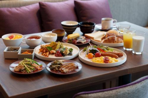 那霸Hotel GrandConsort Naha的餐桌上满盘食物的桌子
