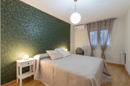 格拉纳达Capricho en el centro de Granada.的一间卧室设有一张床和绿色的墙壁
