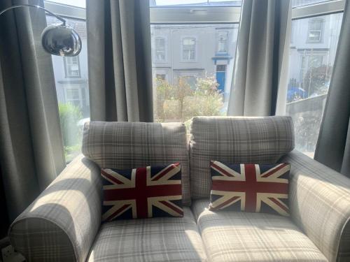 斯旺西F1 16 Glanmor Cres的窗户上带彩旗枕头的沙发