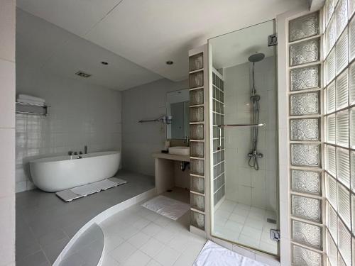 杜马格特Coco Grande Hotel的带浴缸、淋浴和盥洗盆的浴室