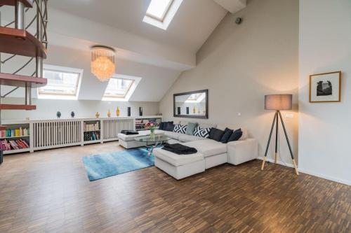 柏林Ruhige Dachwohnung mit Terrasse Berlin MITTE - Spacious modern rooftop loft in Berlin MITTE的客厅配有白色的沙发和桌子