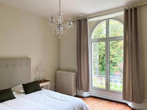 Bonneuil-les-EauxDomaine de Bonneuil的一间卧室设有一张床和一个大窗户