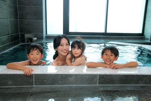 东京ＥＮＴ　ＴＥＲＲＡＣＥ　ＡＳＡＫＵＳＡ的热水浴池中的一名妇女和三名儿童