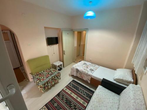 亚洛瓦ALTAY MOTEL的客房设有两张床、椅子和电视。