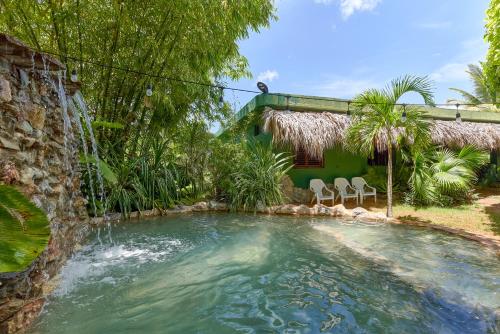 拉斯加勒拉斯CHALET TROPICAL Hotel & Restaurante的后院的瀑布游泳池