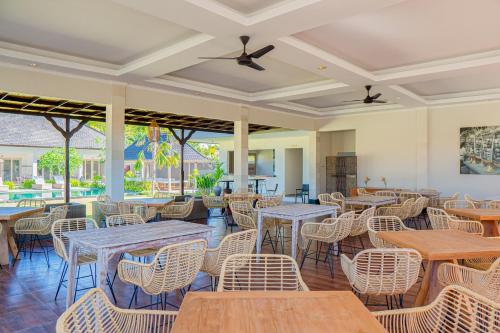 努沙杜瓦Green D'Mel Luxury Homestay的一间带桌椅的餐厅和庭院