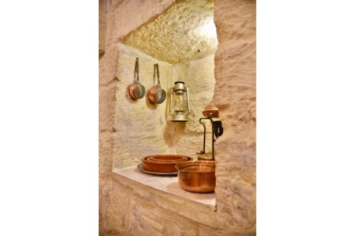 休吉让Ta'Martin Farmhouse Xewkija Gozo的石墙内的厨房,配有锅碗瓢盆