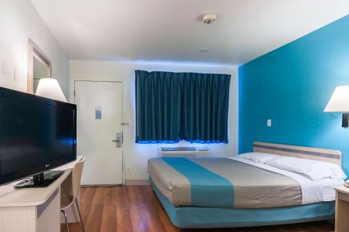 格林里弗格林里弗6号汽车旅馆的一间蓝色卧室,配有一张床和电视
