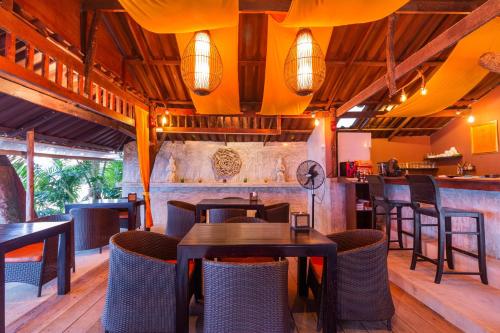 象岛海滩咖啡厅旅馆的一间带桌椅的餐厅和一间酒吧