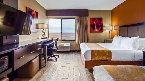 佩吉贝斯维斯特鲍威尔湖酒店 的酒店客房设有两张床、一张桌子和一台电视。