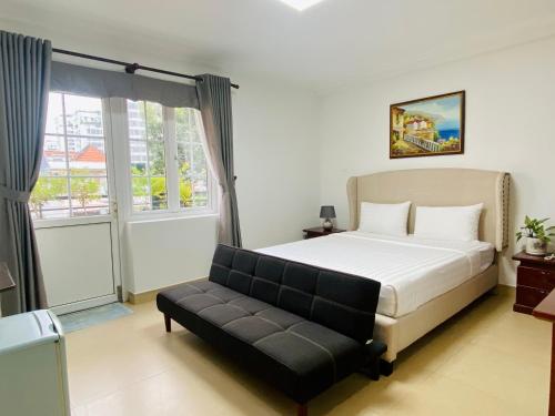 胡志明市LILA Hotel & Apartments的一间卧室配有一张床和一张沙发