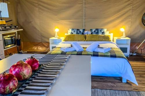 克兰尼蒂African Safari Canvas Lodge Tent Sea View的卧室配有一张铺有石榴的床。