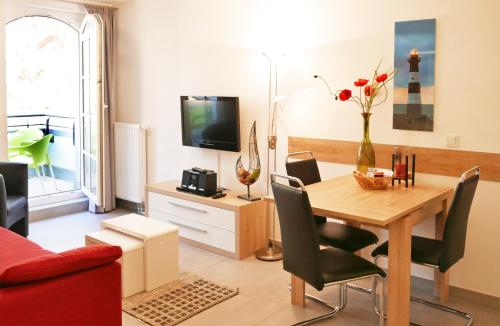 巴贝Haus Meeresblick - Ferienwohnung Sunrise A 2.18 (Ref. 128701)的客厅设有餐桌和电视