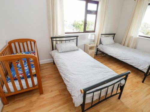 卡拉罗Aras Iosgan的一间卧室配有两张床和一张婴儿床。