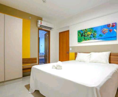 奥林匹亚Olímpia Park Resort-frente Thermas Laranjais-apt 5 p的卧室配有白色的床和墙上的绘画作品