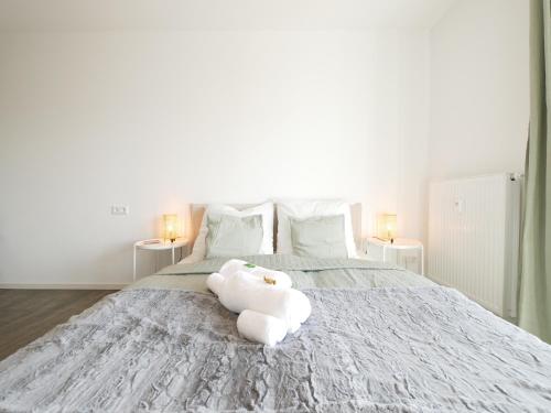 帕德博恩Zentral, modern, gemütlich mit Balkon & Parkplatz的坐在床上的白色毛巾动物