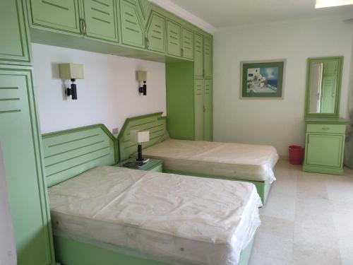 赫尔格达Marena Hurghada的绿柜房内的两张床