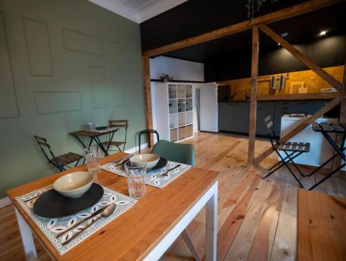 布拉干萨Inn Door 21 - Hostel & Suite的用餐室,配有带碗和盘子的桌子