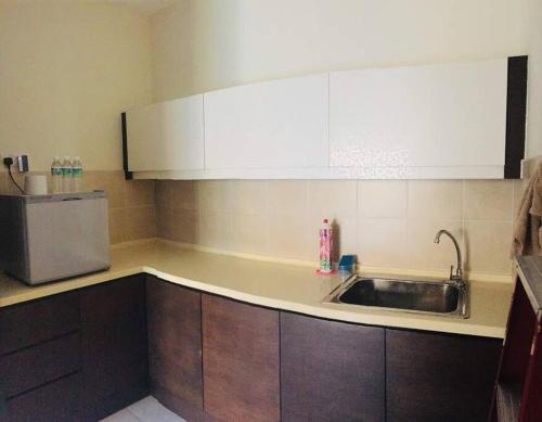 万津Gold Coast Morib Seaview 2 rooms Aircond Apartment的厨房配有水槽和冰箱