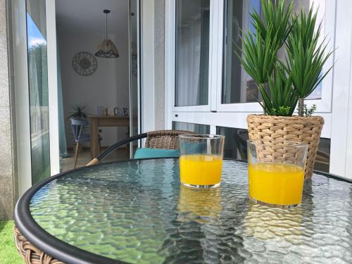 维戈Samil primera línea de playa的玻璃桌旁放两杯橙汁