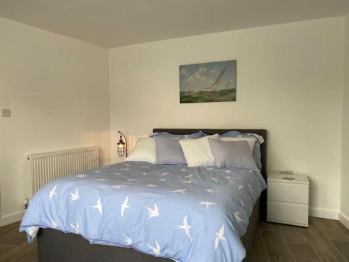 内兹岬附近沃尔顿Lovely 1 bed flat 200 metres from beach的一间卧室配有一张带白色床单的大床