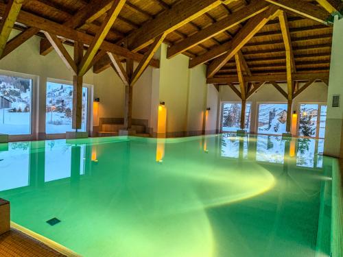 比维奥Ferienwohnung in den Bergen mit grosser Terrasse的大型客房的游泳池设有木制天花板