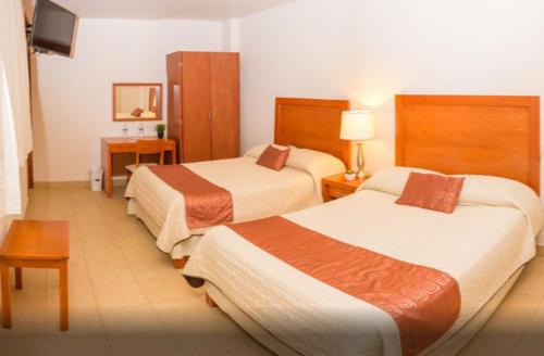 贾拉普Hotel Marllou的酒店客房设有两张床和电视。